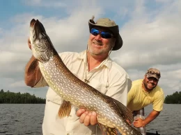 Happy Man Holding Up Northern Pike Catch