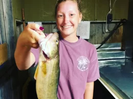Paige Showing Walleye Catch Indoors