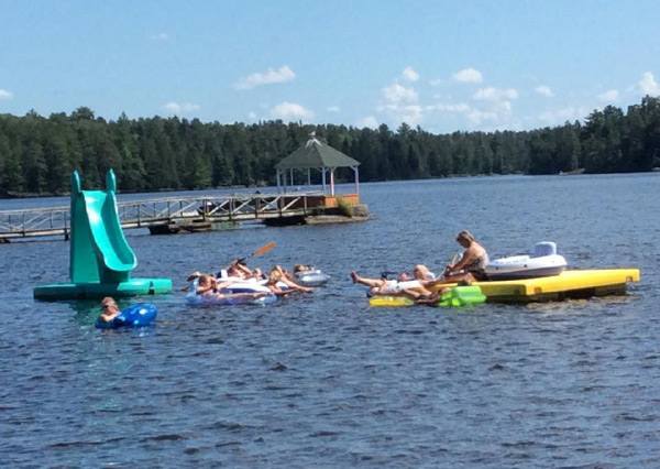 Family Relaxing And Playing On The Lake